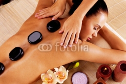 Adult_woman_having_hot_stone_massage_in_spa_salon.jpg